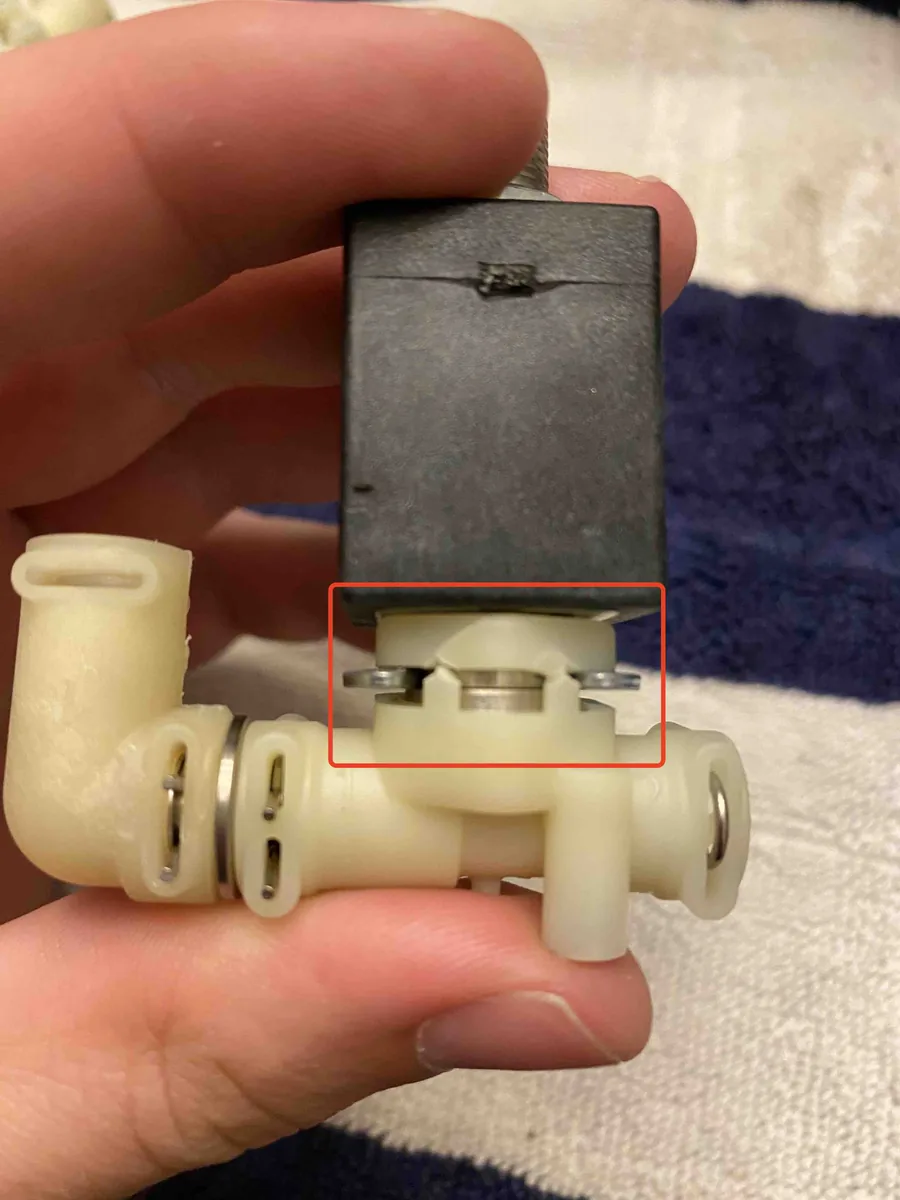 Crack beneath the solenoid valve highlighted with a red rectangle