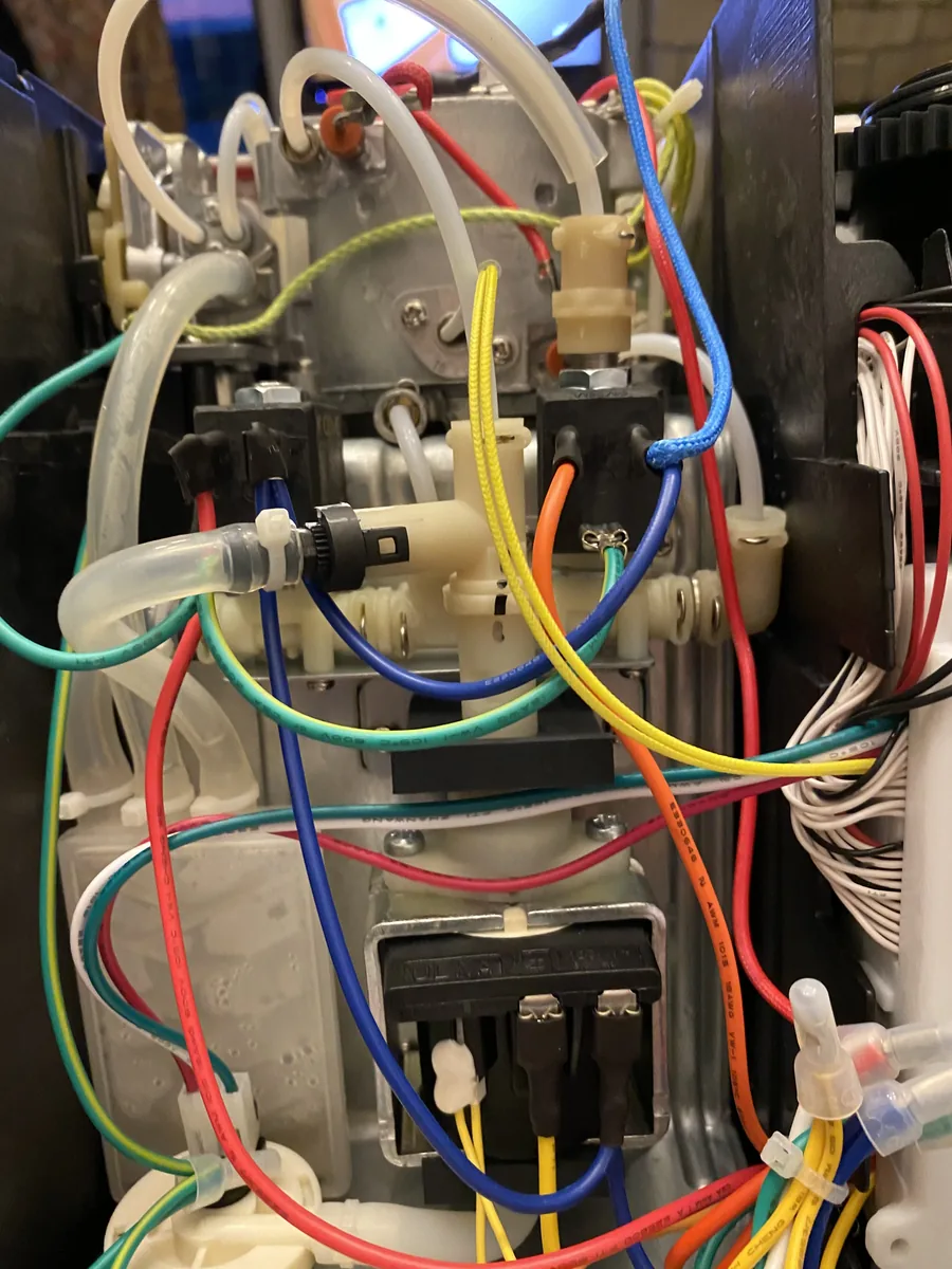 Interior of the espresso machine showing the solenoid valve assembly
